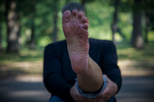 A man pointing his feet directly at us, which is a cultural faux-pas for Thailand