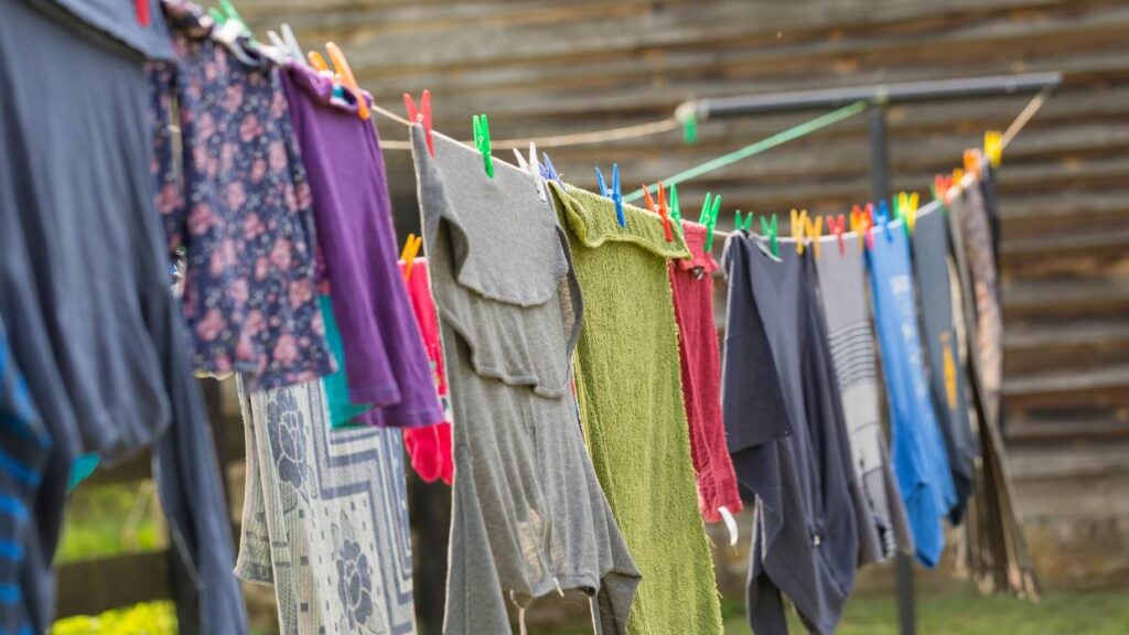 Hanging clothes up to dry because people don't use dryers in Thailand