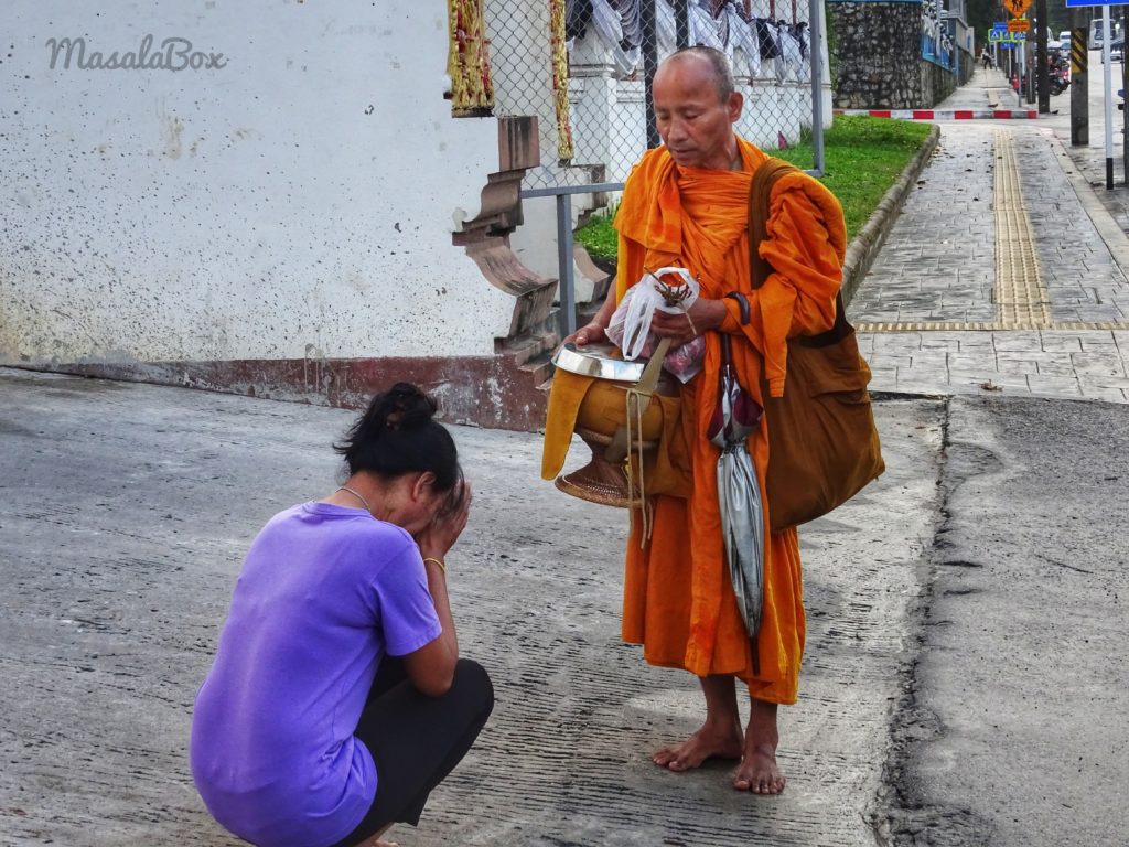 A monk blessing a woman in Thailand