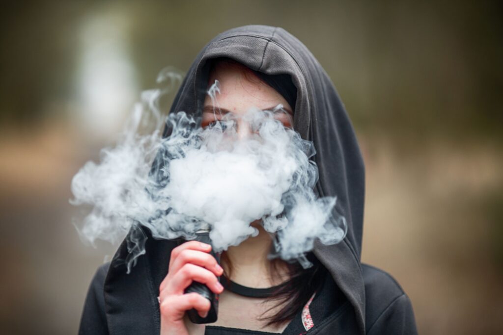 A woman vaping, which is illegal in thailand while marijuana is legal