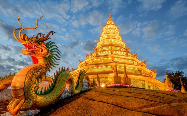 A dragon statue and temple in Thailand.