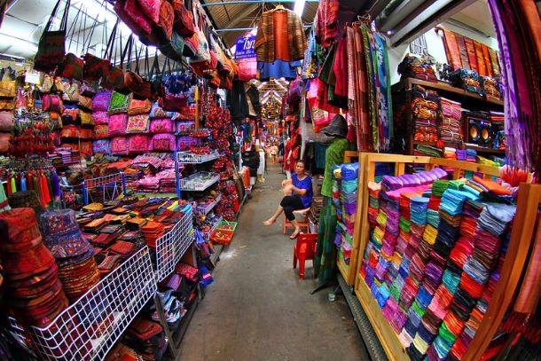 A Thai market showing clothes, purses, hats, and more.